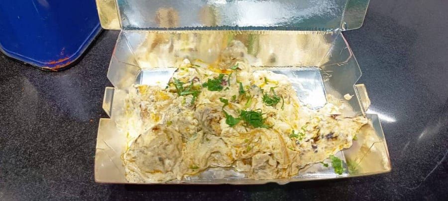 Afghani momos in a takeaway box