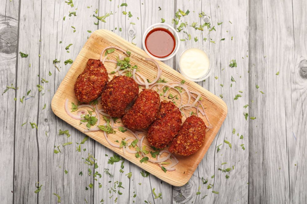 Cheese kurkure momos on a wooden board