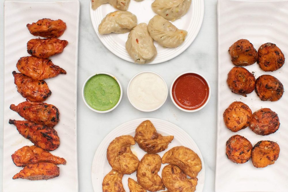 Momo platter with tandoori, steamed and fried momos
