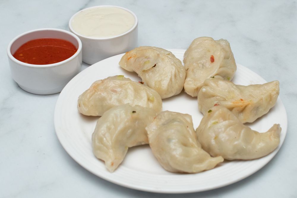 Veg steamed momos with red chutney and mayo